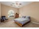 Comfortable bedroom featuring neutral carpet, a cozy armchair, and ample natural light at 3353 E Nolan Dr, Chandler, AZ 85249