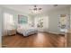 Bright bedroom with wood floors, ceiling fan, large windows and access to the pool at 3353 E Nolan Dr, Chandler, AZ 85249
