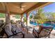 Relaxing covered patio with cushioned seating overlooking the pool and lush backyard at 3353 E Nolan Dr, Chandler, AZ 85249