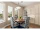 Cozy dining area with a round table, patterned chairs, and ample natural light from the nearby windows at 3353 E Nolan Dr, Chandler, AZ 85249