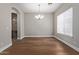 Formal dining room with hardwood floors, chandelier, and adjacent wine room at 3353 E Nolan Dr, Chandler, AZ 85249