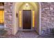 Inviting front entrance with a wooden door, brick accents, and decorative side lights, creating a warm and welcoming ambiance at 3353 E Nolan Dr, Chandler, AZ 85249