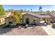 Charming single-story home with stone accents, a well-manicured front yard, and a side-entry three-car garage at 3353 E Nolan Dr, Chandler, AZ 85249