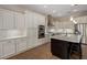 Modern kitchen boasts sleek cabinets, stainless steel appliances, and center island with bar stool seating at 3353 E Nolan Dr, Chandler, AZ 85249