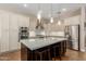 Elegant kitchen featuring a center island with bar seating, stainless steel appliances, and stylish pendant lighting at 3353 E Nolan Dr, Chandler, AZ 85249