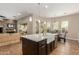 Modern kitchen with a large island, a farmhouse sink, and an open layout that connects to the living area and dining space at 3353 E Nolan Dr, Chandler, AZ 85249