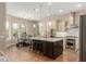 Bright kitchen with a large center island, stainless steel appliances, and an adjacent dining area with patterned chairs at 3353 E Nolan Dr, Chandler, AZ 85249