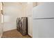 Well-equipped laundry room with washer, dryer, cabinets, and a refrigerator for convenience at 3353 E Nolan Dr, Chandler, AZ 85249