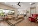 Inviting living room featuring tile floors, neutral-toned sofas, and large windows offering natural light and backyard views at 3353 E Nolan Dr, Chandler, AZ 85249