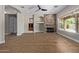 Open living room with stone fireplace, high ceilings, built-in shelving, and large windows overlooking the pool at 3353 E Nolan Dr, Chandler, AZ 85249