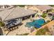 Aerial view of a private backyard oasis with a pool, bar, seating area, and lush landscaping at 3353 E Nolan Dr, Chandler, AZ 85249