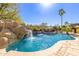 Gorgeous pool with stone waterfall, lush landscaping and resort style vibes at 3353 E Nolan Dr, Chandler, AZ 85249
