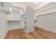 Walk-in closet featuring custom shelves and wood flooring at 3353 E Nolan Dr, Chandler, AZ 85249