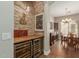 Elegant wine bar area with brick wall, wine refrigerators, and a view into the dining room at 3353 E Nolan Dr, Chandler, AZ 85249