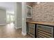 Charming wine bar area featuring brick accent wall, wood countertop, and dual wine refrigerators at 3353 E Nolan Dr, Chandler, AZ 85249