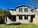 Stunning backyard featuring a lush green lawn, brick patio, and a charming two-story home at 3471 E Azalea Dr, Gilbert, AZ 85298