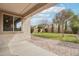 Covered patio that looks onto a lush, green backyard with a brick paver pathway at 3471 E Azalea Dr, Gilbert, AZ 85298
