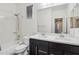 Bathroom featuring a bathtub, shower, and double vanity with black cabinets at 3471 E Azalea Dr, Gilbert, AZ 85298