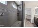 Modern bathroom featuring a tiled shower with rainfall showerhead and glass mosaic accent at 3471 E Azalea Dr, Gilbert, AZ 85298