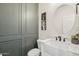 Charming powder room with white sink, designer mirror, and custom wainscoting at 3471 E Azalea Dr, Gilbert, AZ 85298