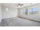 Neutral primary bedroom with carpet, ceiling fan, and ample light from large windows at 3471 E Azalea Dr, Gilbert, AZ 85298