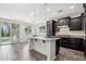 Modern kitchen with a center island, dark cabinets, and stainless steel appliances at 3471 E Azalea Dr, Gilbert, AZ 85298