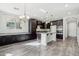 Open-concept kitchen featuring dark cabinets, granite countertops, and stainless steel appliances at 3471 E Azalea Dr, Gilbert, AZ 85298