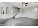 Neutral living room with carpet, stairs, and an arched entryway at 3471 E Azalea Dr, Gilbert, AZ 85298