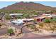 Aerial view of the Carefree entrance with shops, street view, and mountain views in the background at 37801 N Cave Creek Rd # 11, Cave Creek, AZ 85331