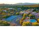 An aerial view of tennis court and nearby community pool with mountains in the background at 37801 N Cave Creek Rd # 11, Cave Creek, AZ 85331