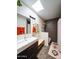 Modern bathroom with a sleek vanity, large mirror, skylight, and combination shower and tub at 37801 N Cave Creek Rd # 11, Cave Creek, AZ 85331