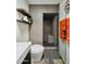 Modern bathroom featuring walk-in shower with glass door, floating shelves, and orange towels at 37801 N Cave Creek Rd # 11, Cave Creek, AZ 85331