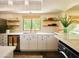 Bright kitchen featuring white cabinets, modern appliances, and a large window with a view of the outdoors at 37801 N Cave Creek Rd # 11, Cave Creek, AZ 85331