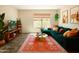 Cozy living room with a green sofa, area rug, and large windows for natural light at 37801 N Cave Creek Rd # 11, Cave Creek, AZ 85331