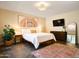 Inviting main bedroom with king bed, patterned rug, warm lighting, and decorative wall art at 37801 N Cave Creek Rd # 11, Cave Creek, AZ 85331