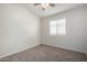 A cozy bedroom features neutral paint, plush carpet, and a ceiling fan for added comfort at 3847 W Yellow Peak Dr, San Tan Valley, AZ 85144