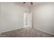 The carpeted bedroom has an open doorway to a connected room at 3847 W Yellow Peak Dr, San Tan Valley, AZ 85144
