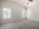 A spacious bedroom boasts vaulted ceilings, multiple windows, and plush carpeting for comfort at 3847 W Yellow Peak Dr, San Tan Valley, AZ 85144