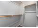 A walk-in closet has wooden rods, shelving, and neutral carpet at 3847 W Yellow Peak Dr, San Tan Valley, AZ 85144