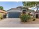 Charming single-story home featuring a two-car garage and a well-maintained front yard with colorful desert landscaping at 3847 W Yellow Peak Dr, San Tan Valley, AZ 85144