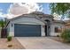 Beautiful single-story home featuring a two-car garage, desert landscaping, and an arched entry way at 3847 W Yellow Peak Dr, San Tan Valley, AZ 85144