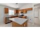 Clean, bright kitchen with wood cabinets, stainless appliances, island, and tile flooring at 3847 W Yellow Peak Dr, San Tan Valley, AZ 85144