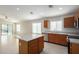 Open kitchen with stainless appliances, tile flooring, eat-in dining space, and abundant natural light at 3847 W Yellow Peak Dr, San Tan Valley, AZ 85144