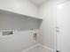 This laundry room features tile floors, utility hookups, and a storage shelf at 3847 W Yellow Peak Dr, San Tan Valley, AZ 85144