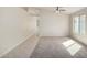Bright living room featuring carpet, ceiling fan, and neutral paint providing versatility at 3847 W Yellow Peak Dr, San Tan Valley, AZ 85144