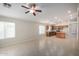 Spacious living room with tile floors, ceiling fan, and kitchen access, perfect for entertaining at 3847 W Yellow Peak Dr, San Tan Valley, AZ 85144