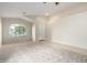 Bright living room featuring carpet, ceiling fan, arched window, and a tiled entry at 3847 W Yellow Peak Dr, San Tan Valley, AZ 85144