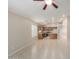 Well-lit living area and kitchen with tile floors, ceiling fan, stainless appliances, and wood cabinets at 3847 W Yellow Peak Dr, San Tan Valley, AZ 85144