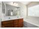 Large main bathroom with dual vanity, soaking tub, separate shower, and bright natural light at 3847 W Yellow Peak Dr, San Tan Valley, AZ 85144
