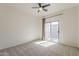 Bedroom featuring neutral carpet, sliding glass doors, and a ceiling fan at 3935 E Rough Rider Rd # 1264, Phoenix, AZ 85050